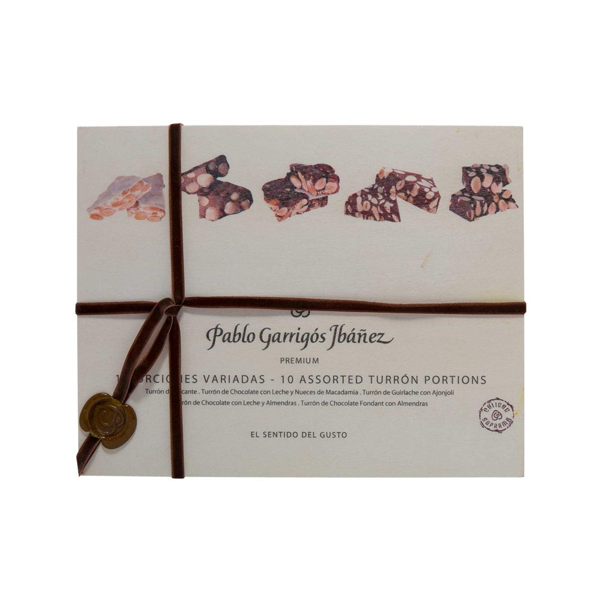 Assorted turron portions gift box with ribbon, printed chocolate pieces and brand name