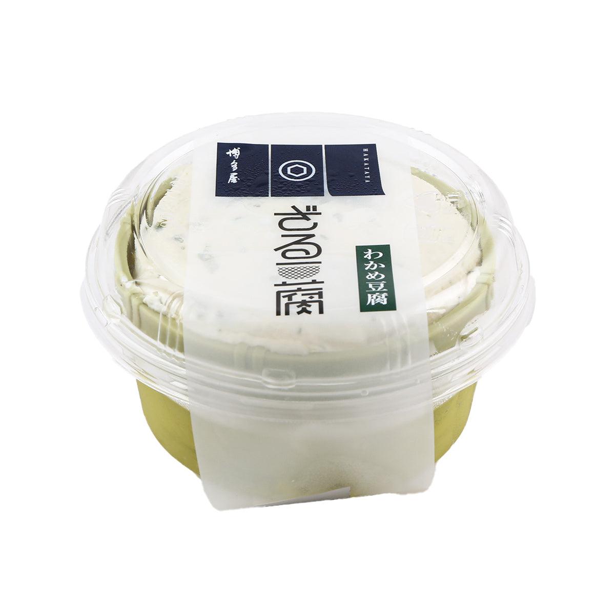 Seaweed zaru tofu cup in clear plastic container; pale tofu with green seaweed garnish
