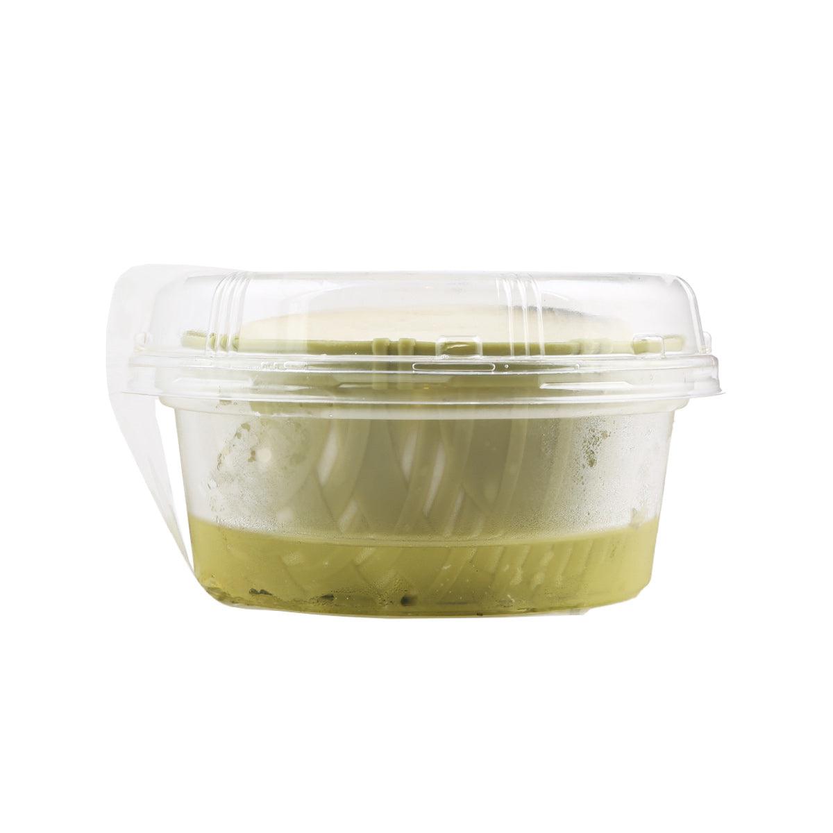 Mustard zaru tofu in clear plastic cup showing pale tofu and green paste