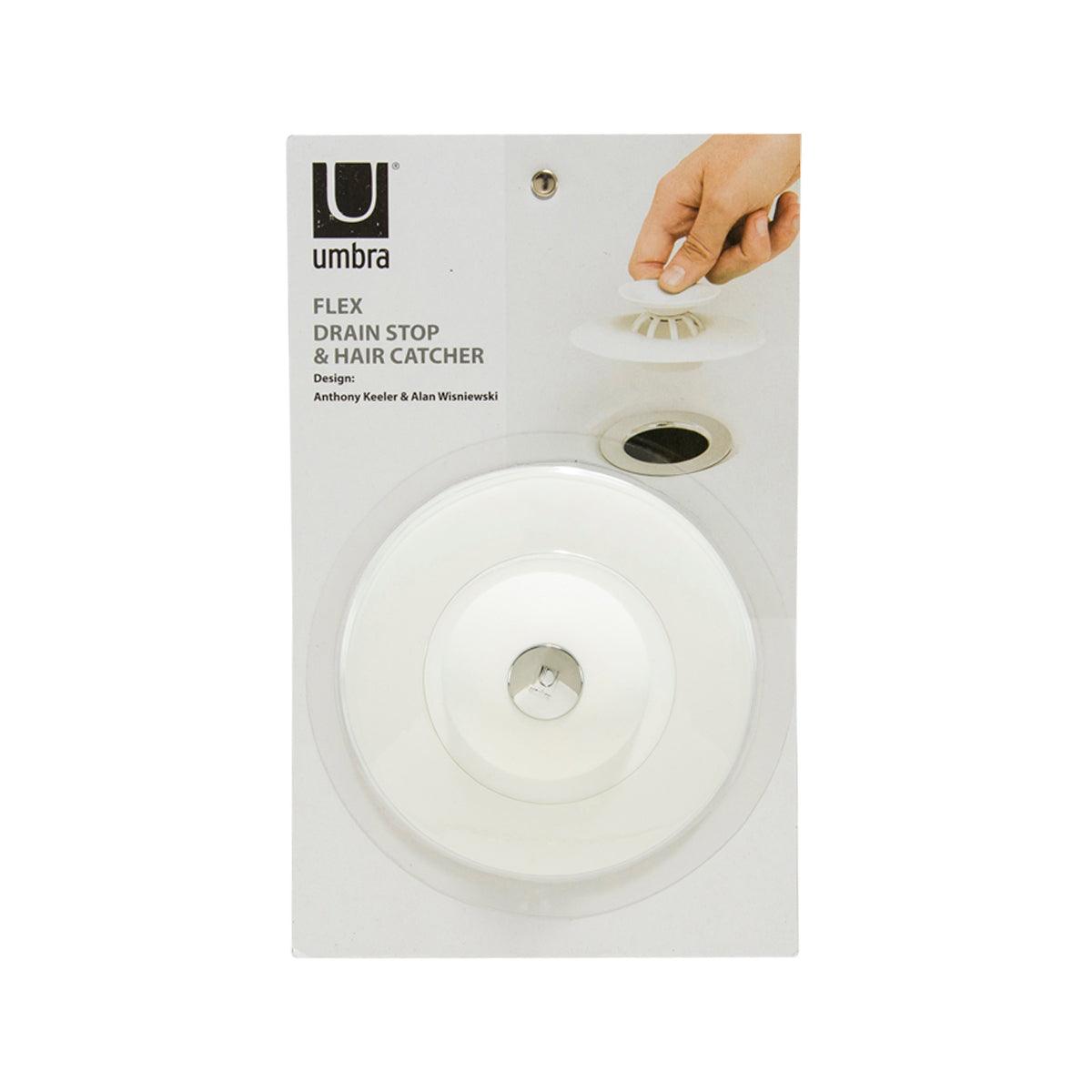 White circular drain stop and hair catcher with central metal strainer insert