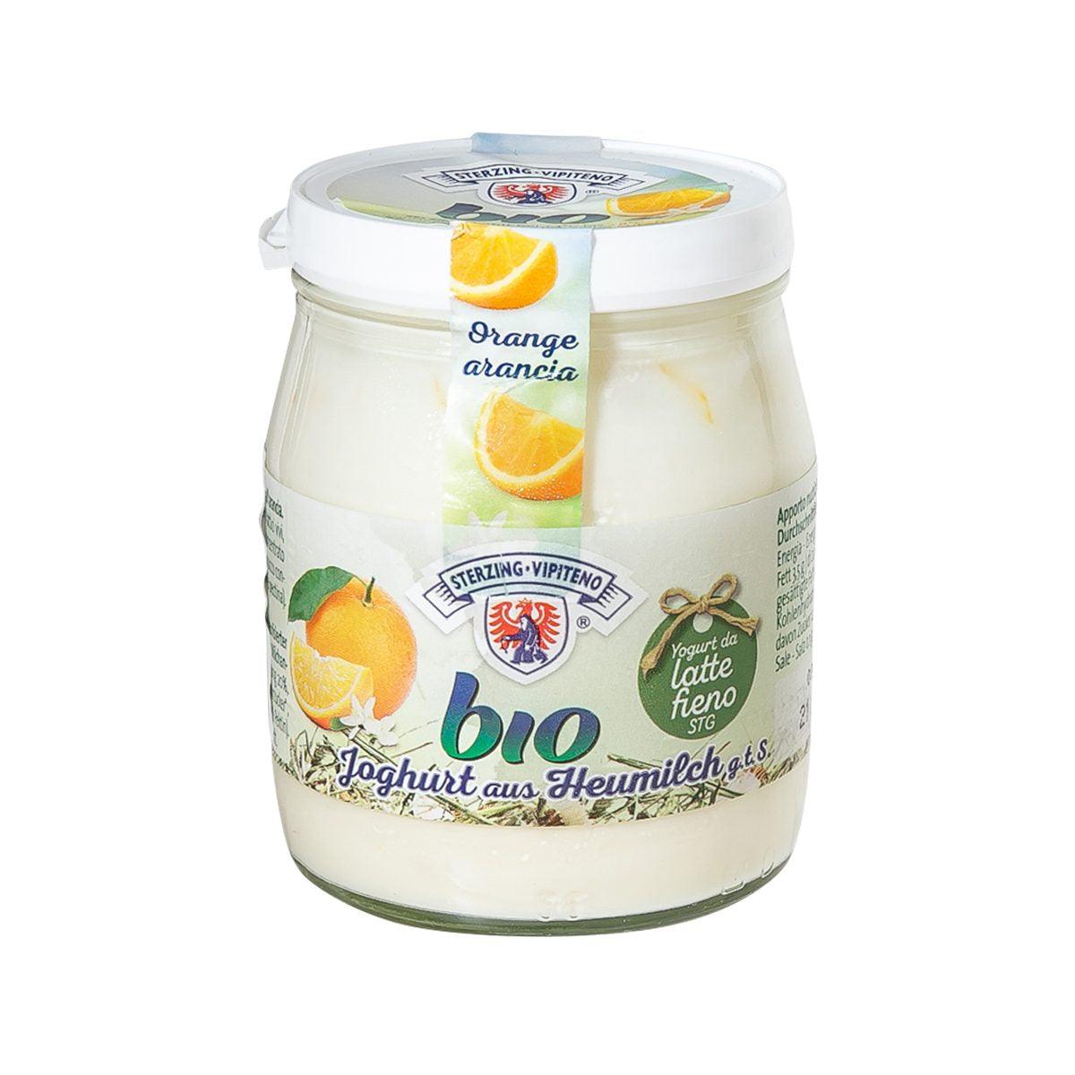 Organic yogurt jar with orange flavor label and creamy white yogurt, sealed lid
