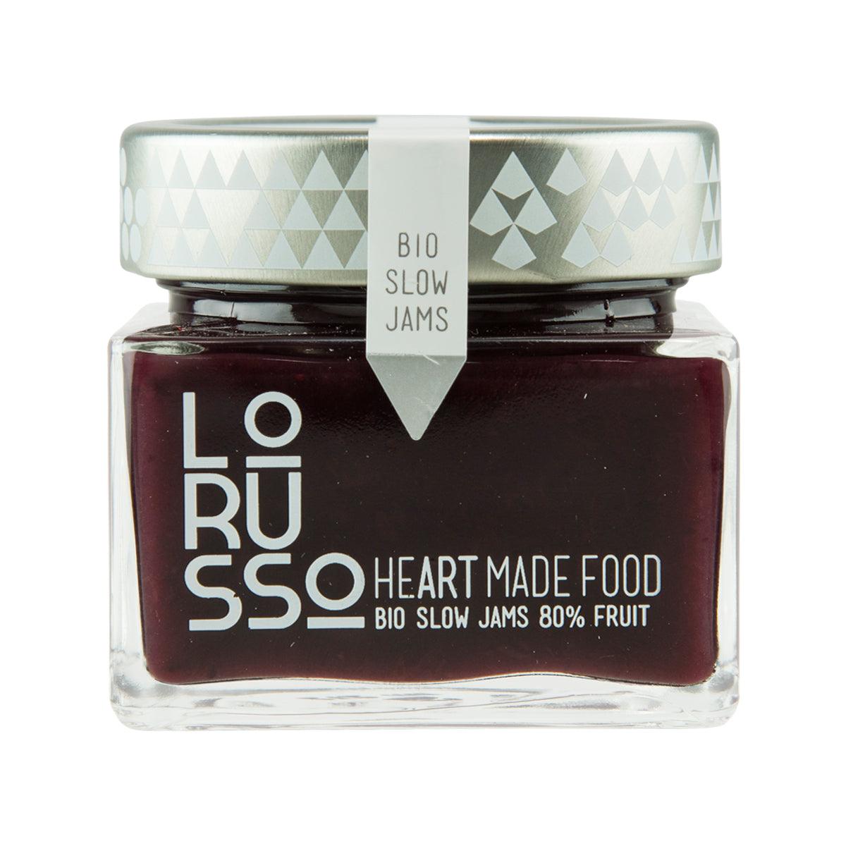 Organic blueberry jam jar, dark filling, white cap, “80% fruit” label