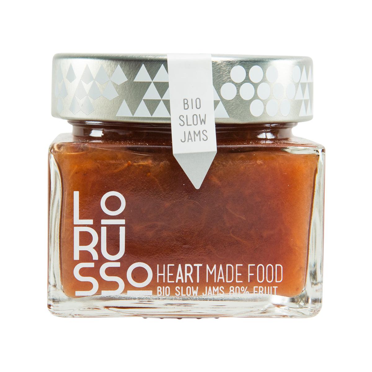 Organic strawberry jam in glass jar with patterned lid and BIO slow jams label