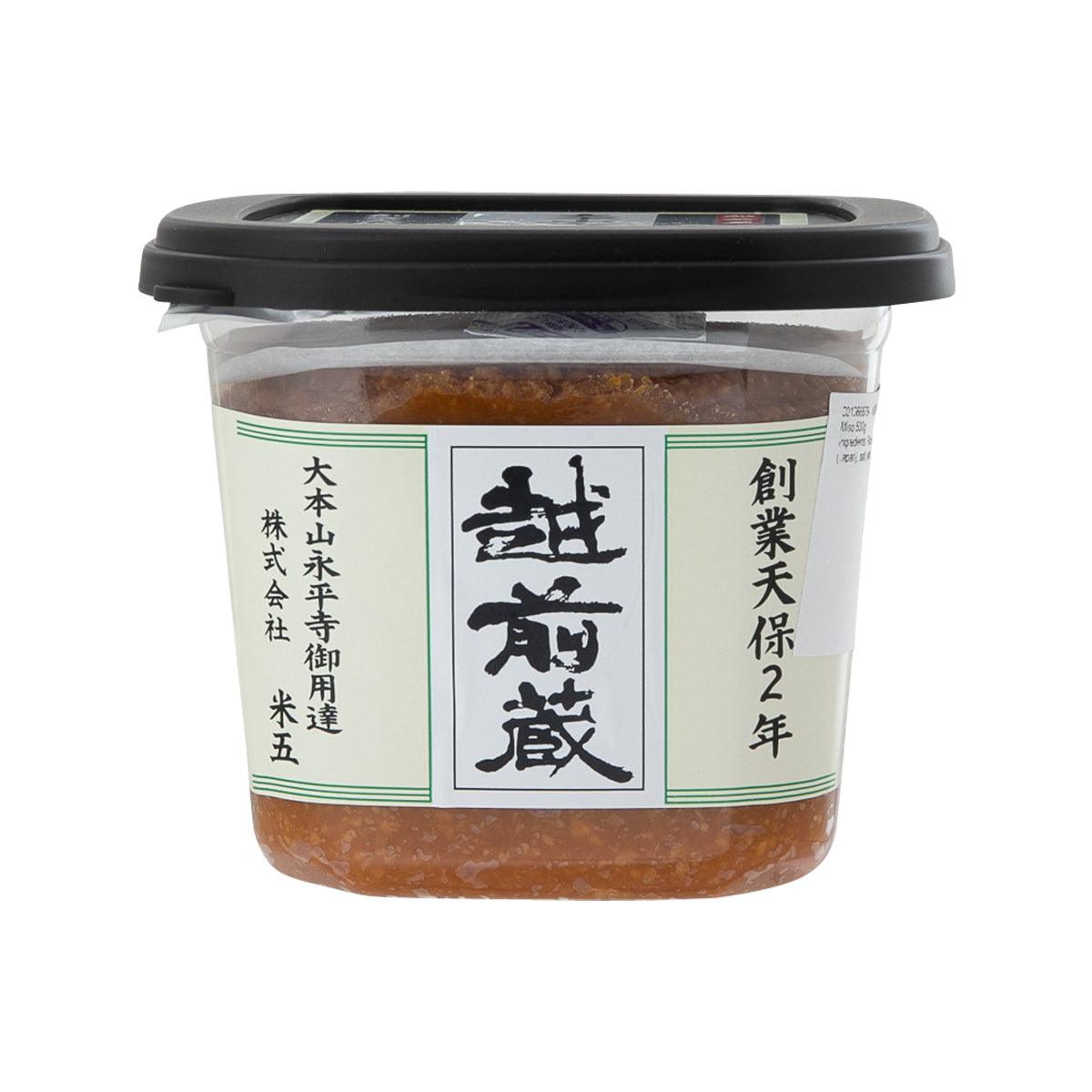 Miso paste in clear plastic tub with black lid, green-and-white front label.