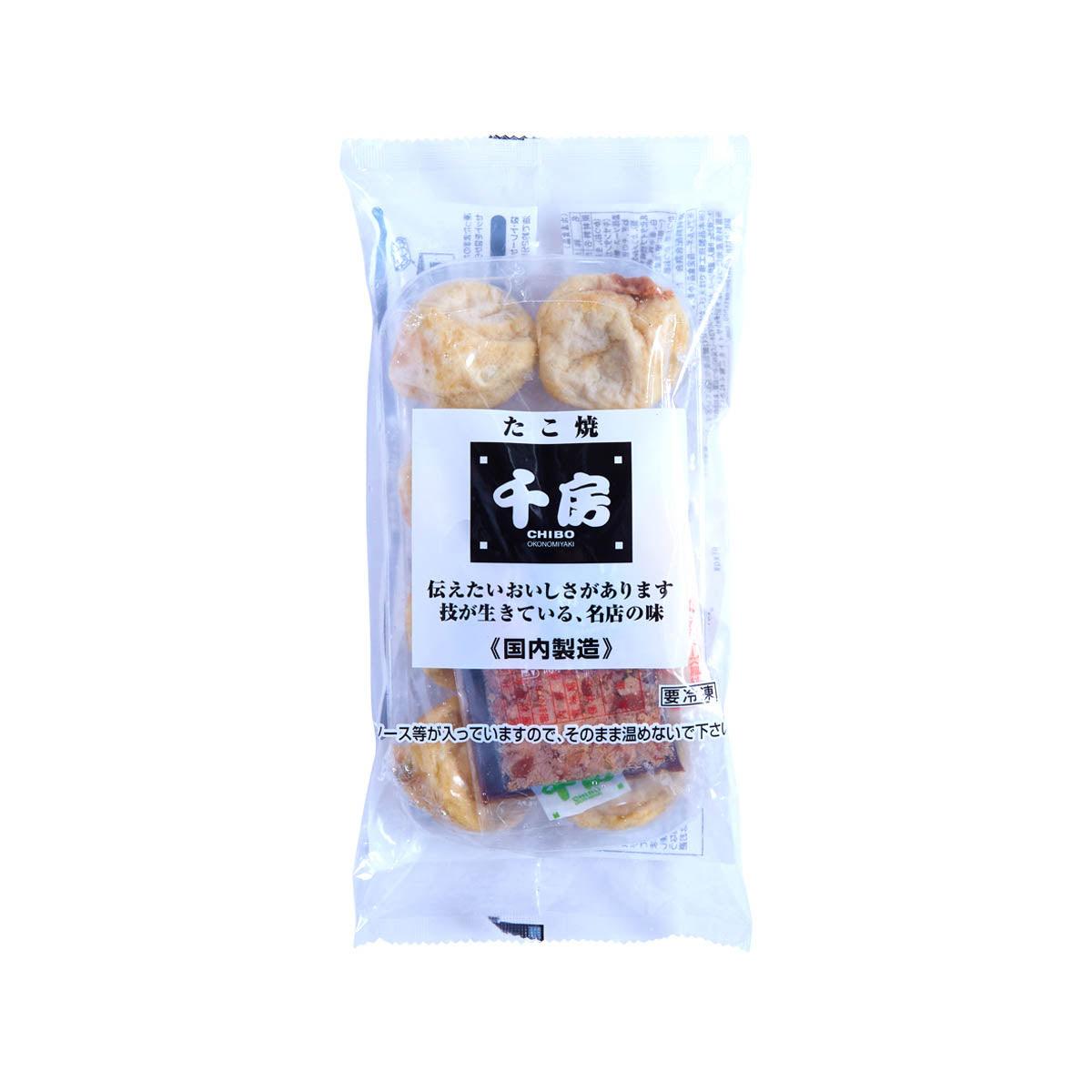 Frozen takoyaki snack in clear bag, with two round pieces and sauce pack