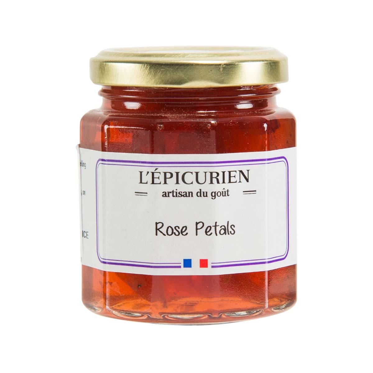 Rose petals spread in glass jar with gold lid, red jam label