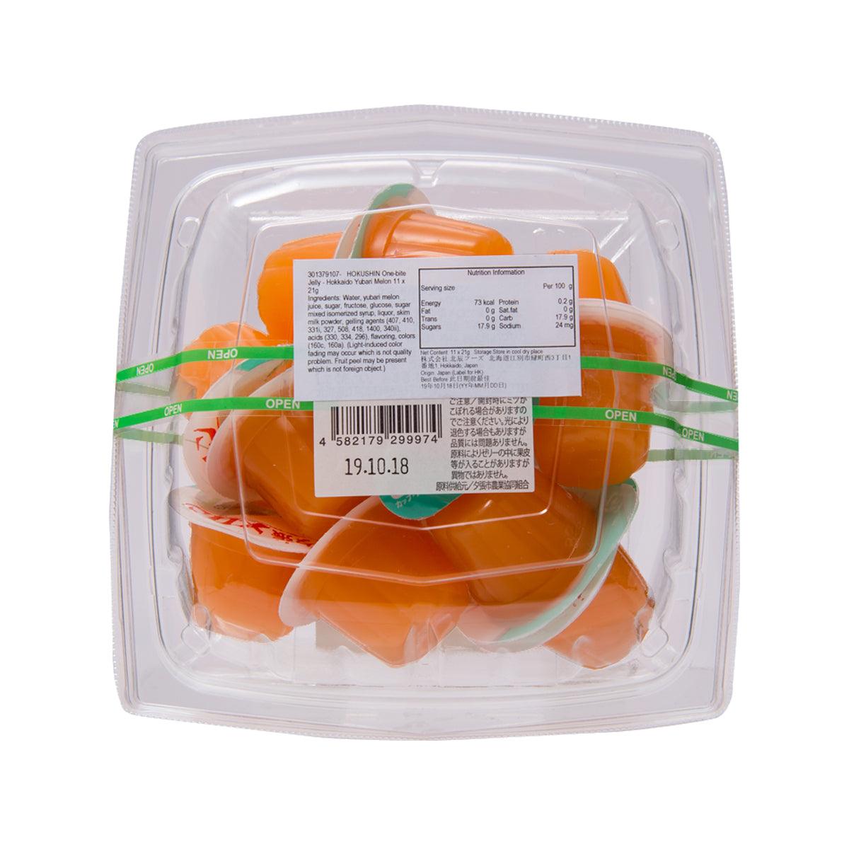 One-bite melon jelly in clear plastic tray with back label and orange jelly pieces
