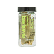 Organic bay leaves in clear glass jar with black lid