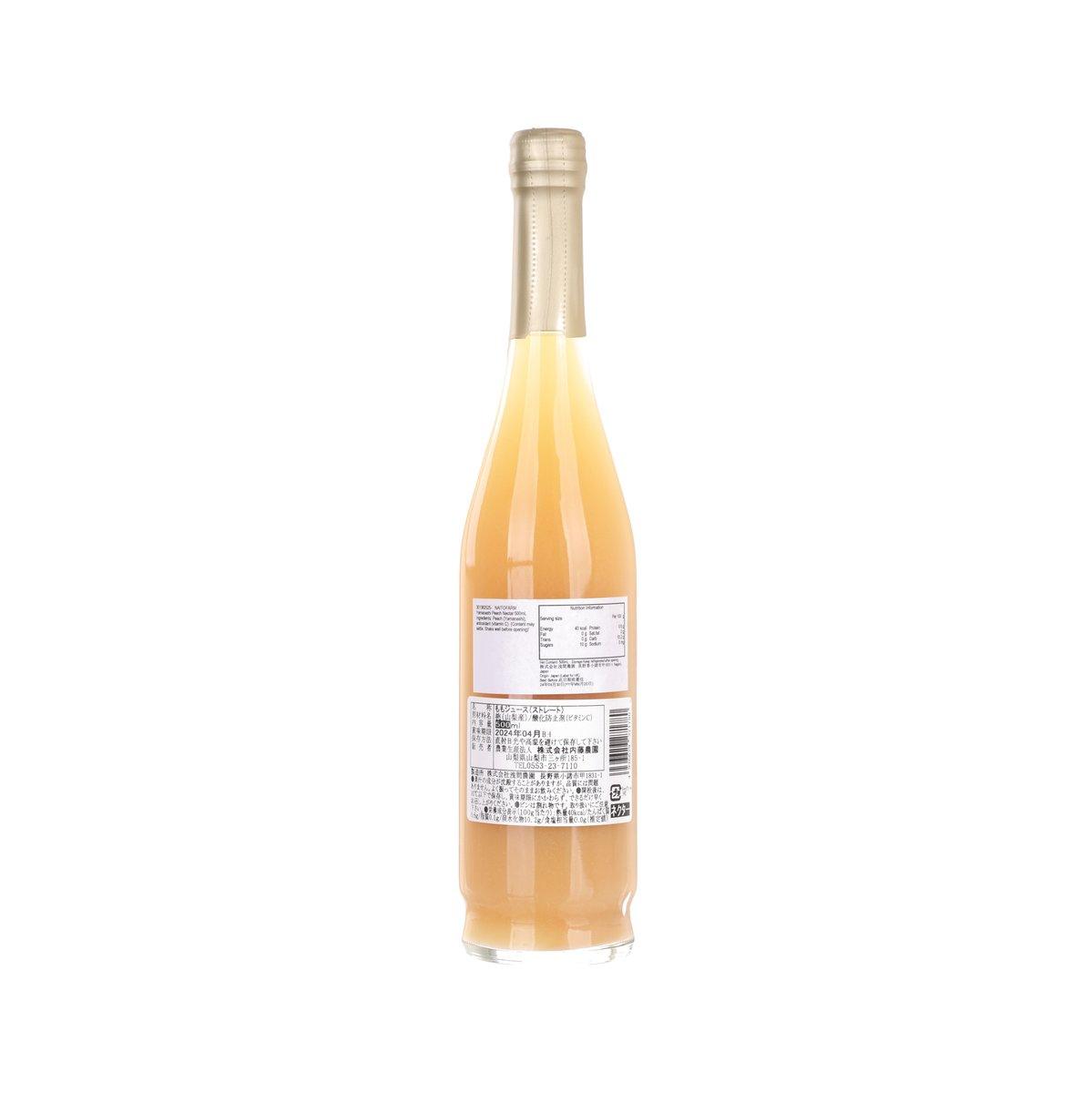 Peach nectar bottle with amber liquid and barcode back label, capped neck