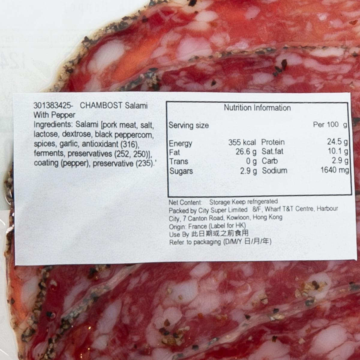 Pepper salami with nutrition label on wrapper, red cured meat and white flecks