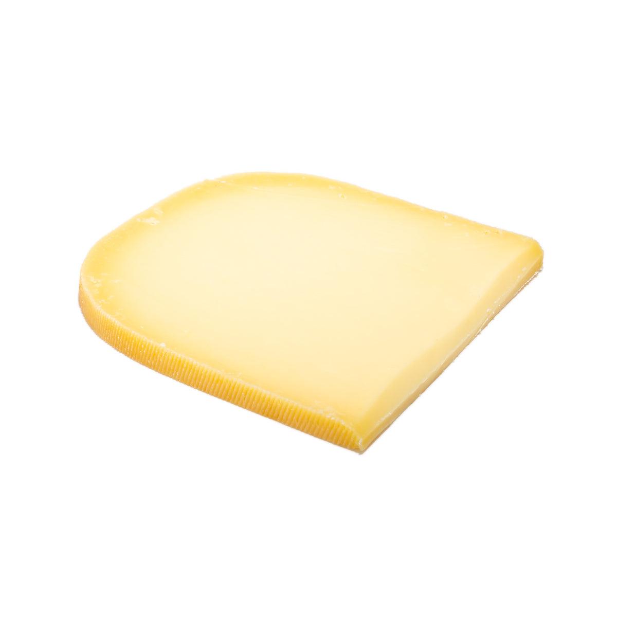 Mild Gouda cheese wedge, pale yellow, smooth surface and rind edge