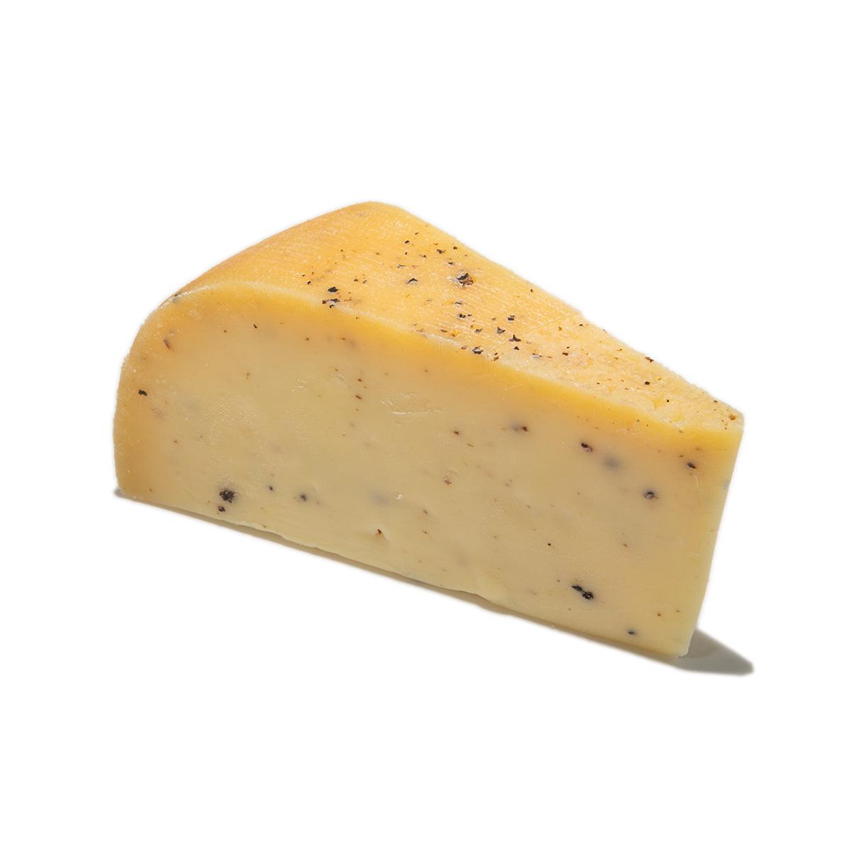 LANDANA truffle gouda cheese wedge, yellow cheese with dark truffle specks