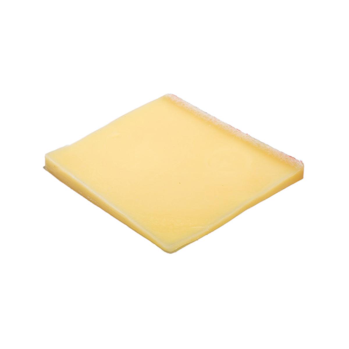 Emmi Emmentaler cheese wedge, pale yellow with smooth rind