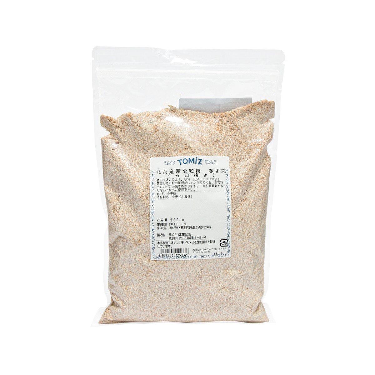 Stone-ground whole wheat flour pouch, 500 g, with TOMIZAWA label on front