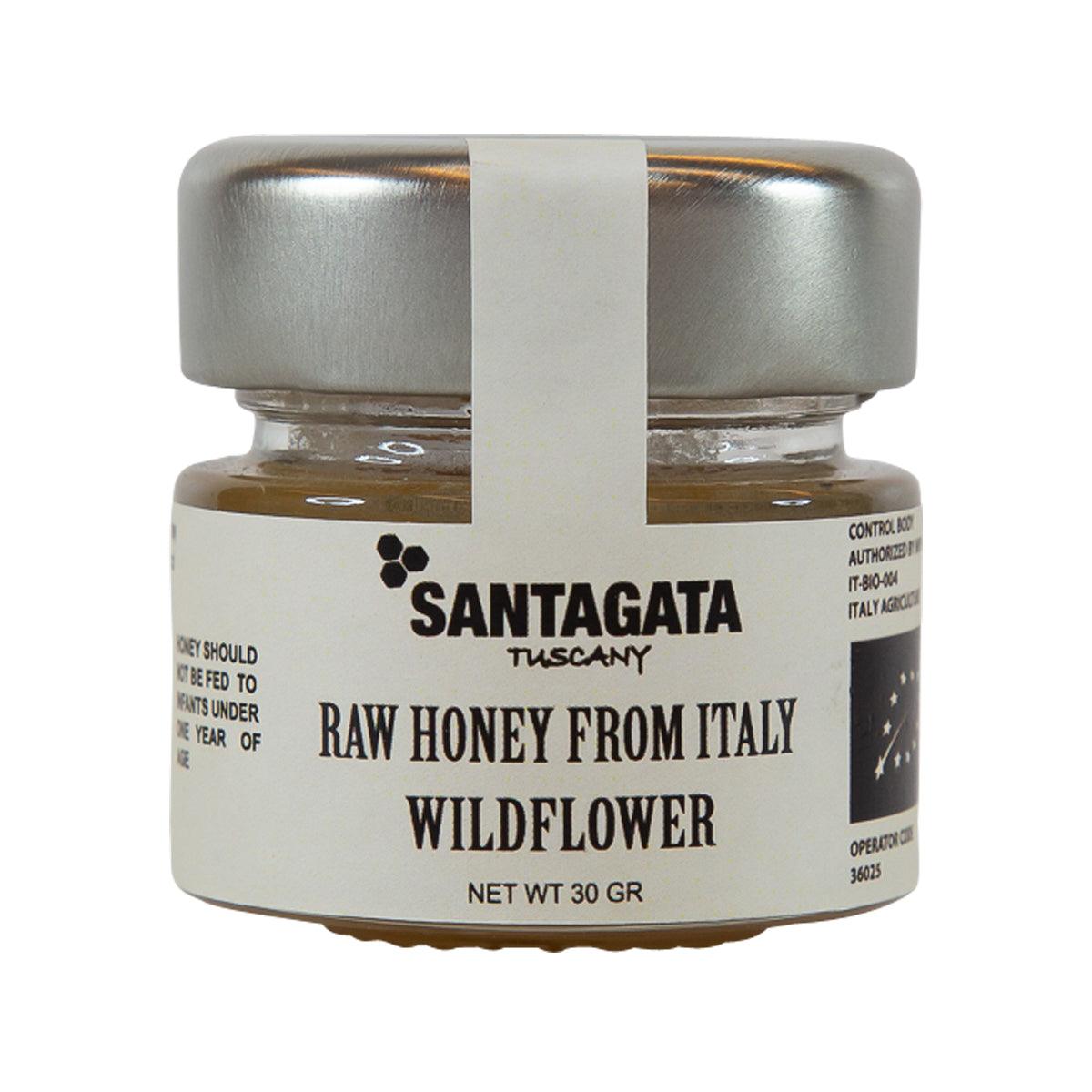Wildflower honey jar with silver lid, clear glass showing amber honey