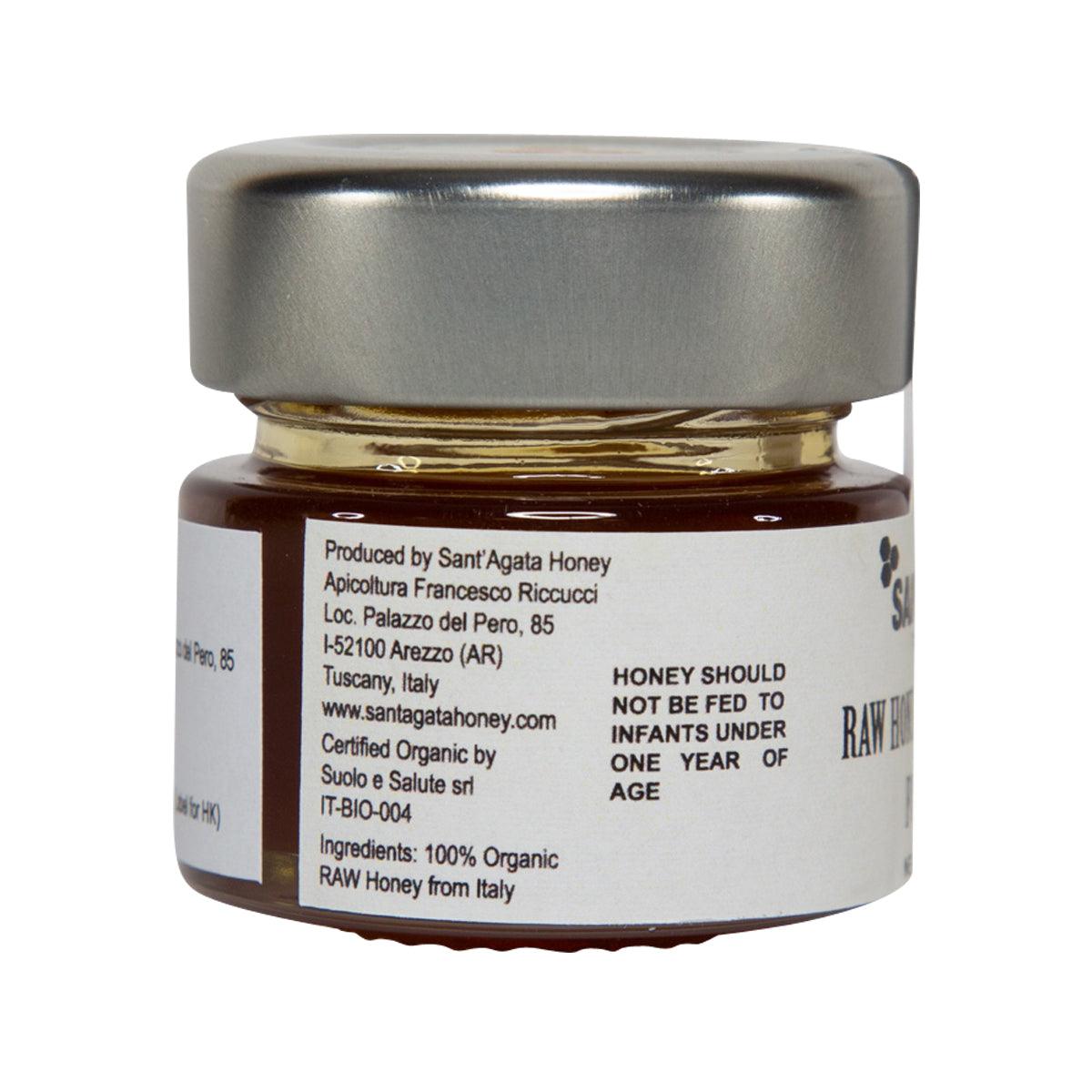 Organic raw forest honey jar, amber contents in glass, SANT' AGATA back label