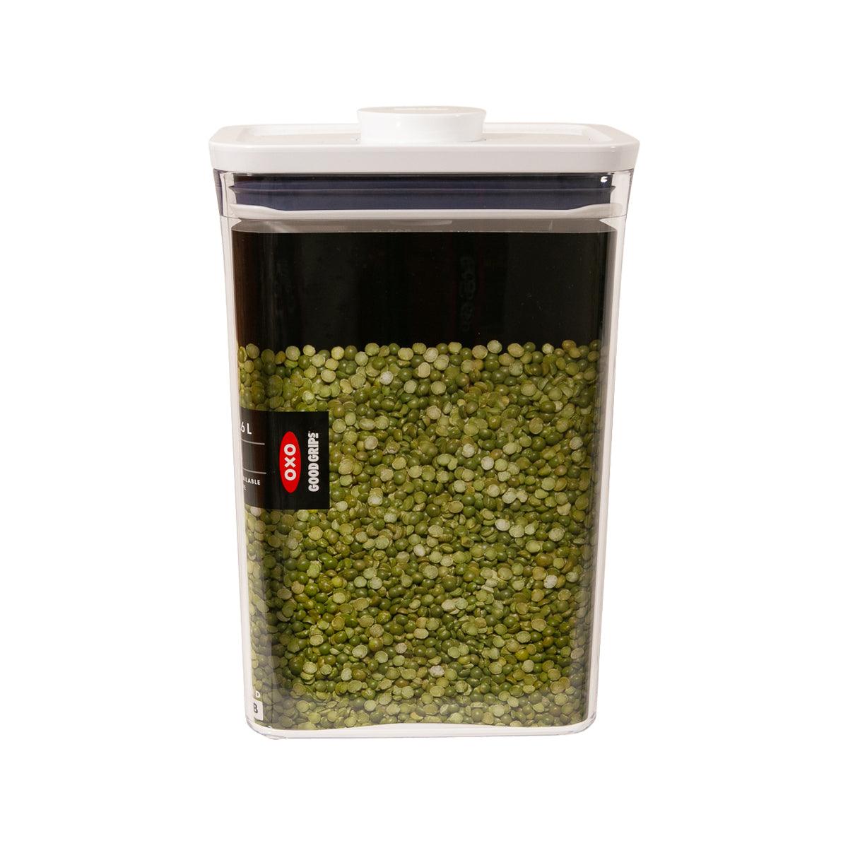 OXO POP rectangle food container, clear body with white lid, filled with green peas