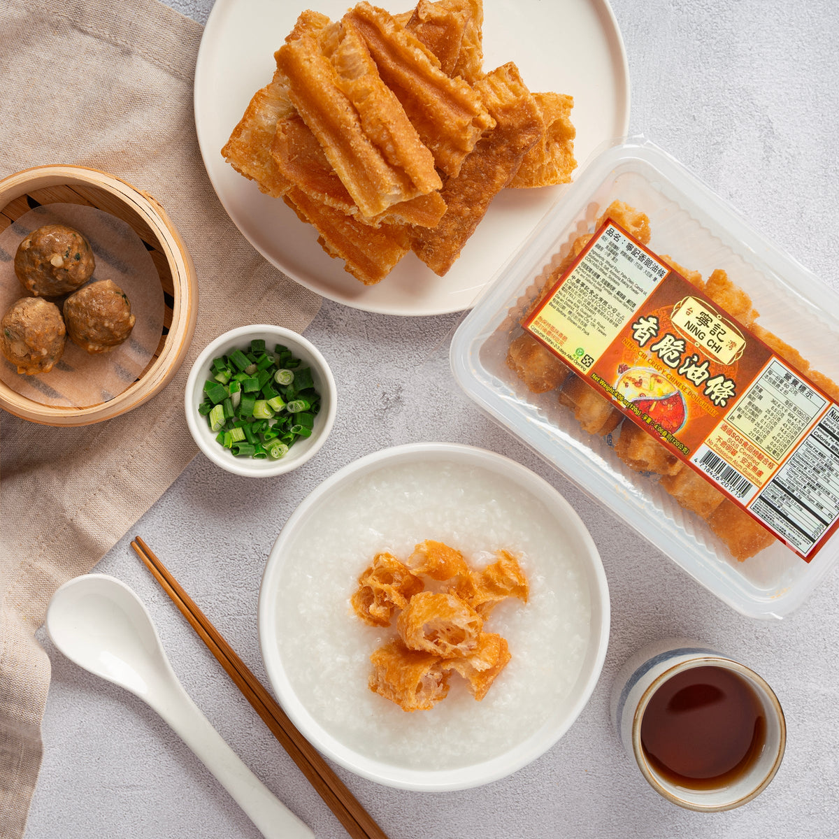 Crispy orange doughnut pieces on plate, with dipping sauce and packaged tray