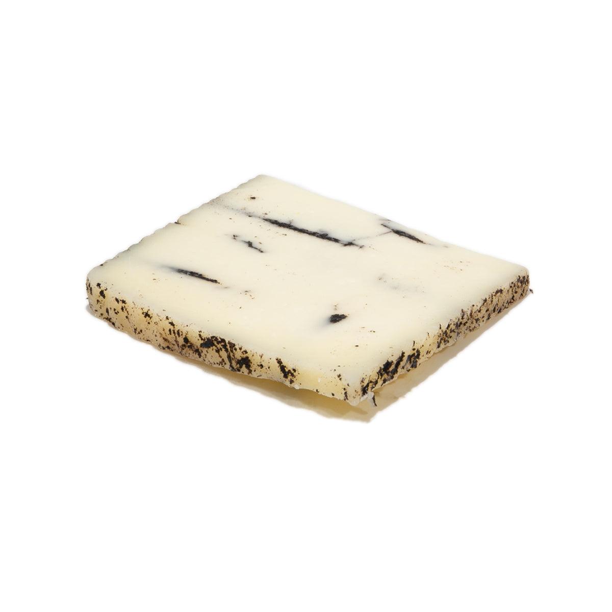 LA LEYENDA sheep milk cheese with black truffle, white wedge with dark specks