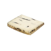 LA LEYENDA sheep milk cheese with black truffle, white wedge with dark specks