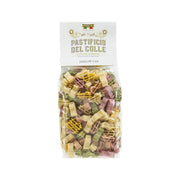Colorful dollar-sign pasta in sealed 500 g bag, with multicolor pasta pieces visible