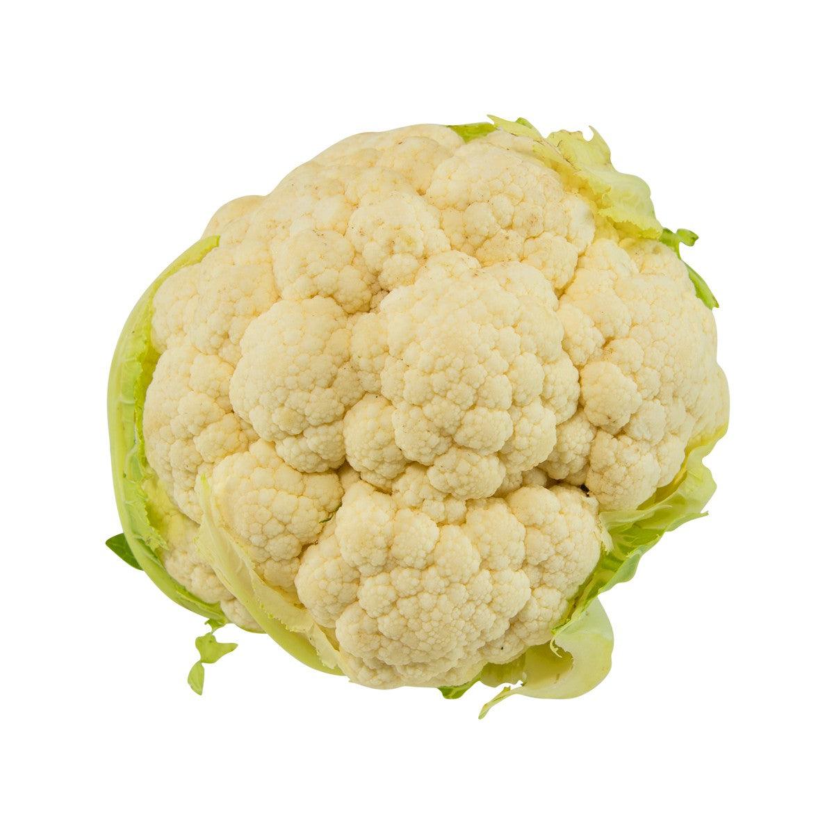 Whole white cauliflower head with pale cream florets and green leaves