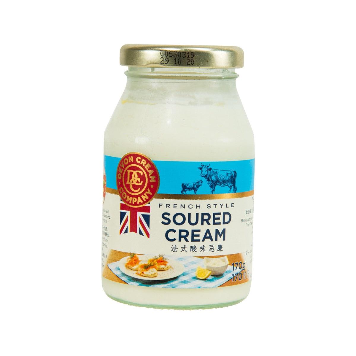Glass jar of French style soured cream with gold lid and blue label