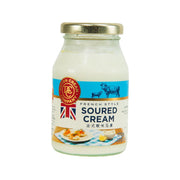 Glass jar of French style soured cream with gold lid and blue label