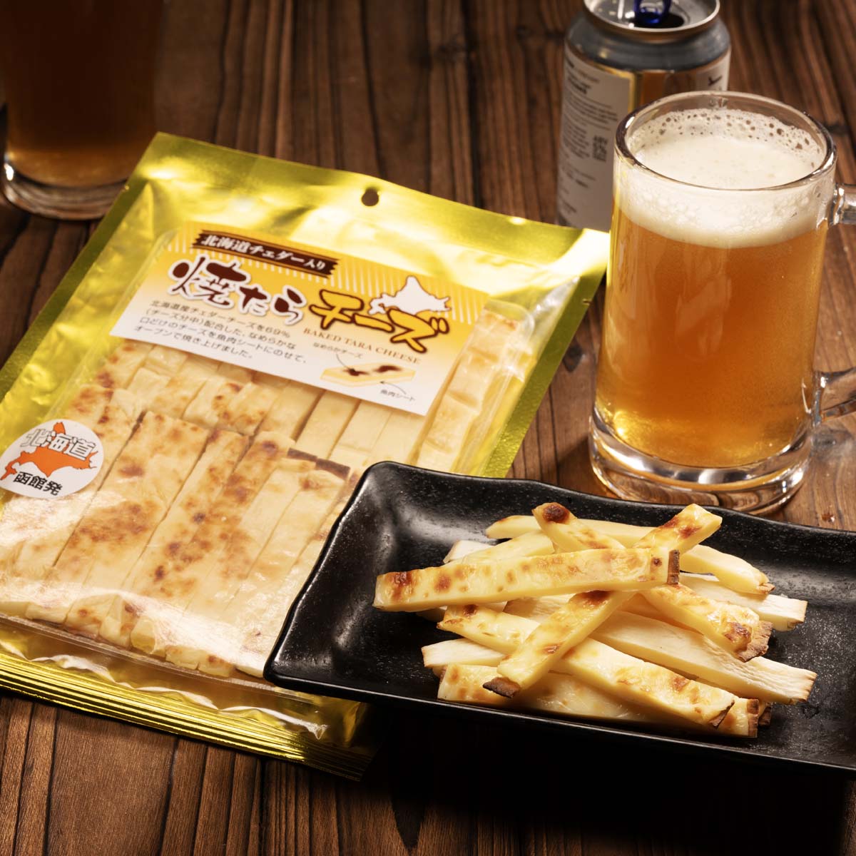 Grilled cheddar cheese with dried cod snack pouch with cheese sticks on tray
