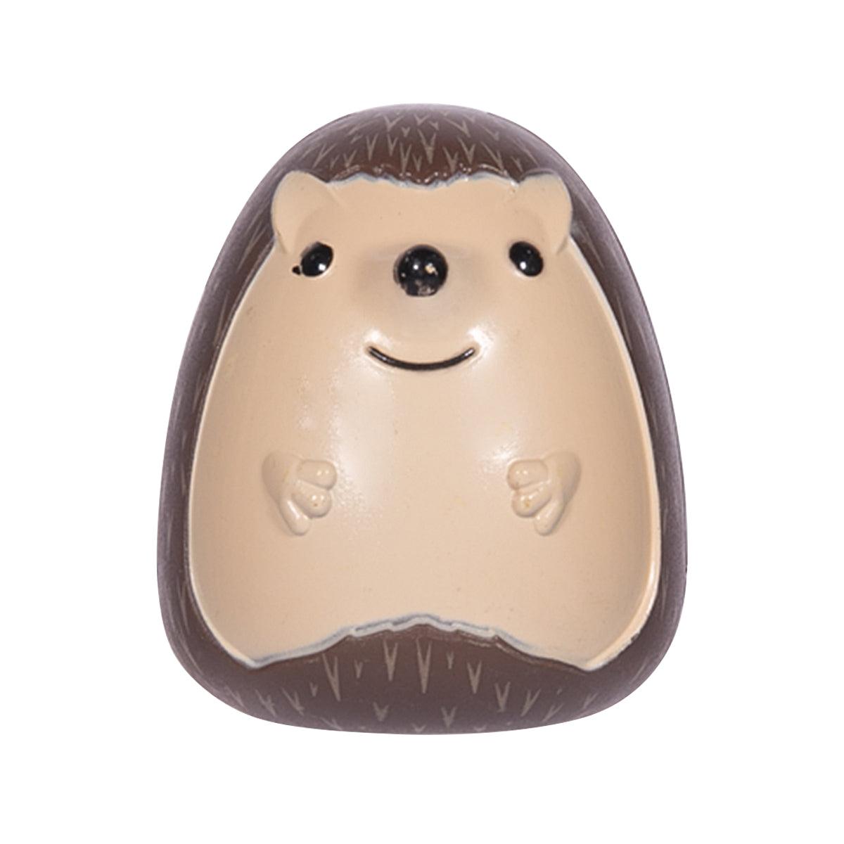 Hedgehog-shaped toothbrush holder with cream face and dark brown spines
