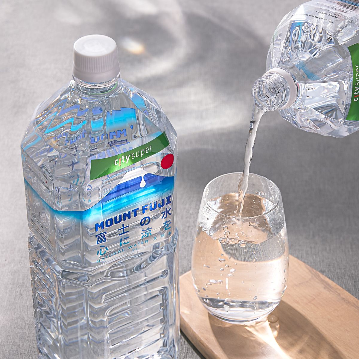 CITYSUPER Mount Fuji natural water bottles with pouring stream into glass