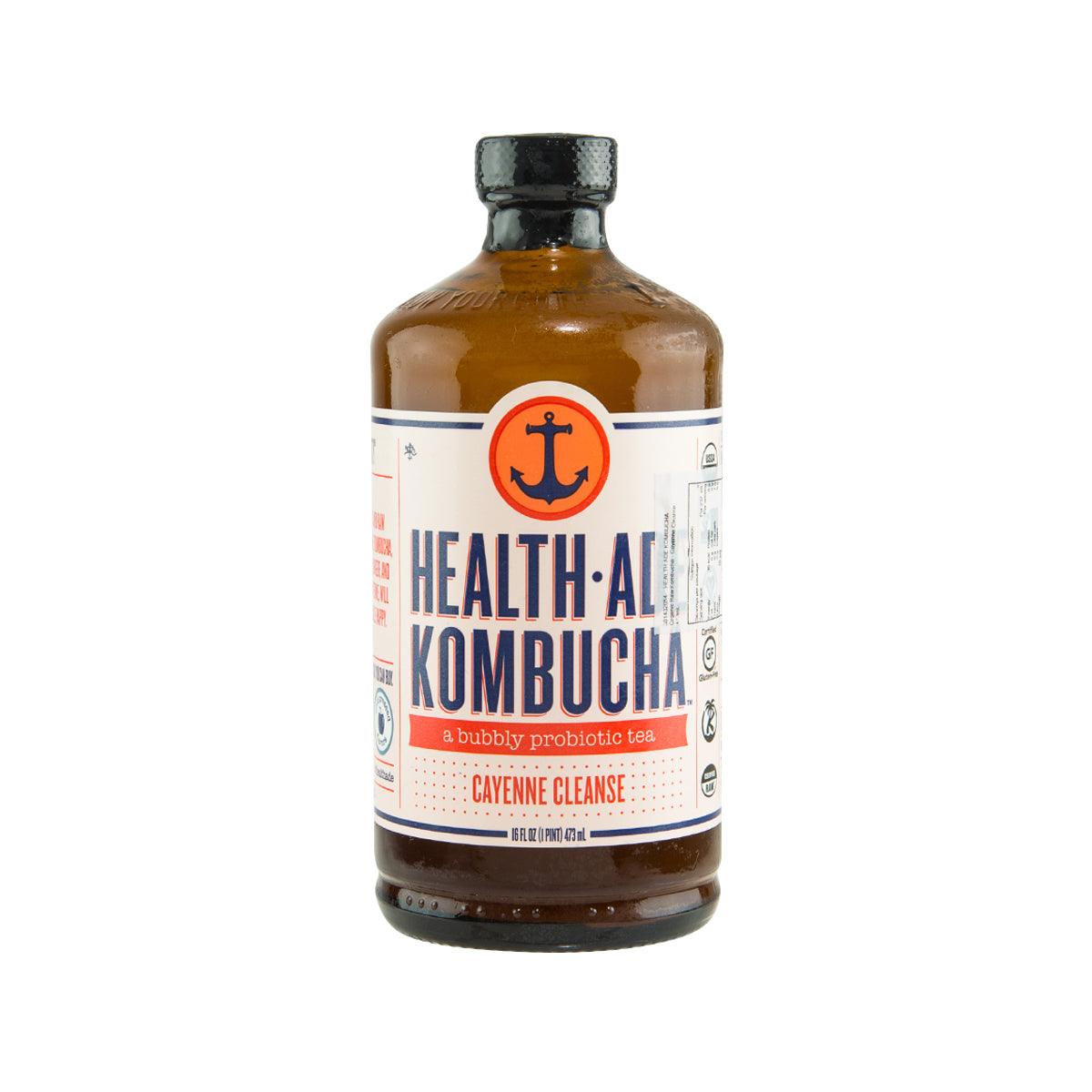 Kombucha bottle with amber liquid and HEALTH ADE label, cayenne cleanse variant