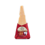 Aged hard cheese wedge in red wrap with label