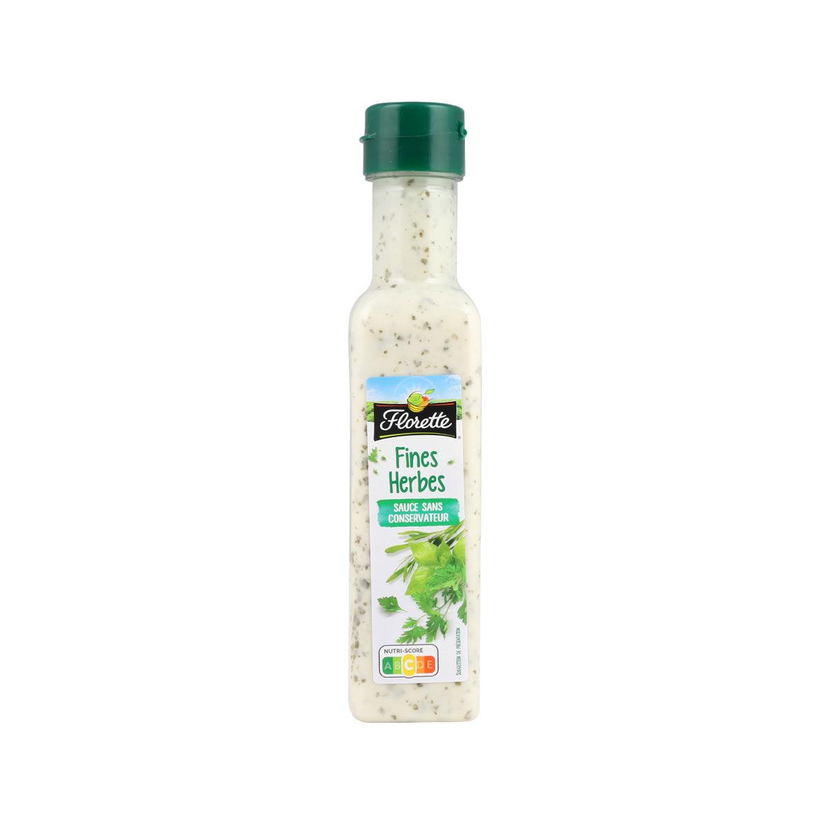 French salad sauce bottle with green cap, pale beige fine herb dressing