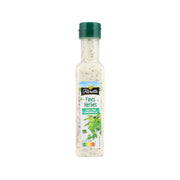 French salad sauce bottle with green cap, pale beige fine herb dressing