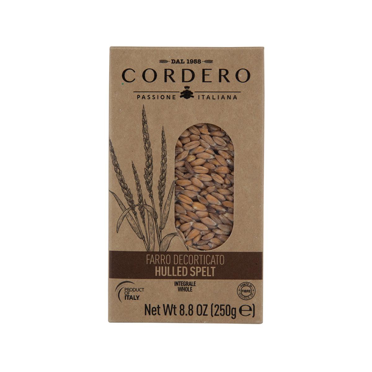 Hulled spelt grain in kraft cardboard box with window showing beige kernels