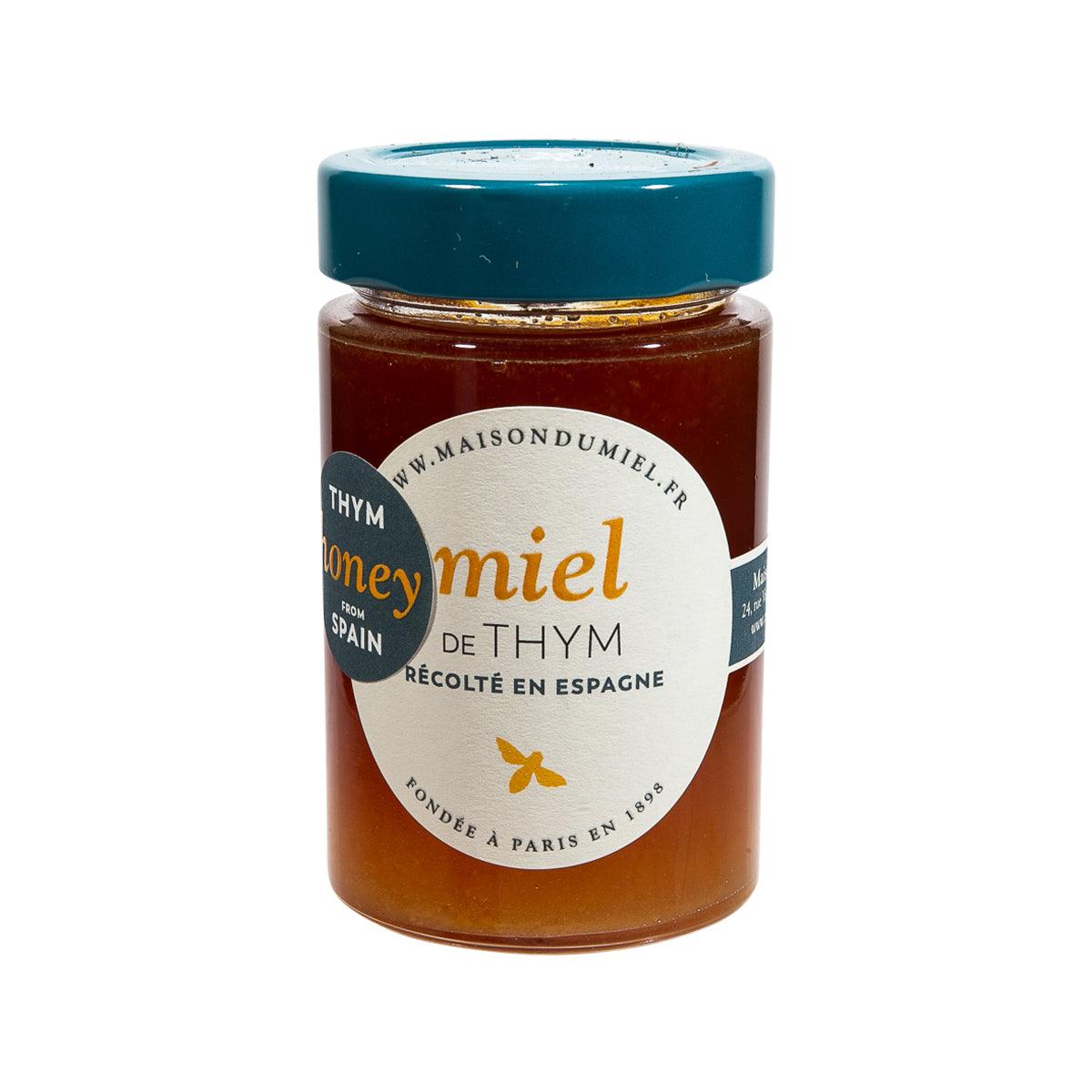 Thyme blossom honey jar with teal lid and amber glass, gold label details