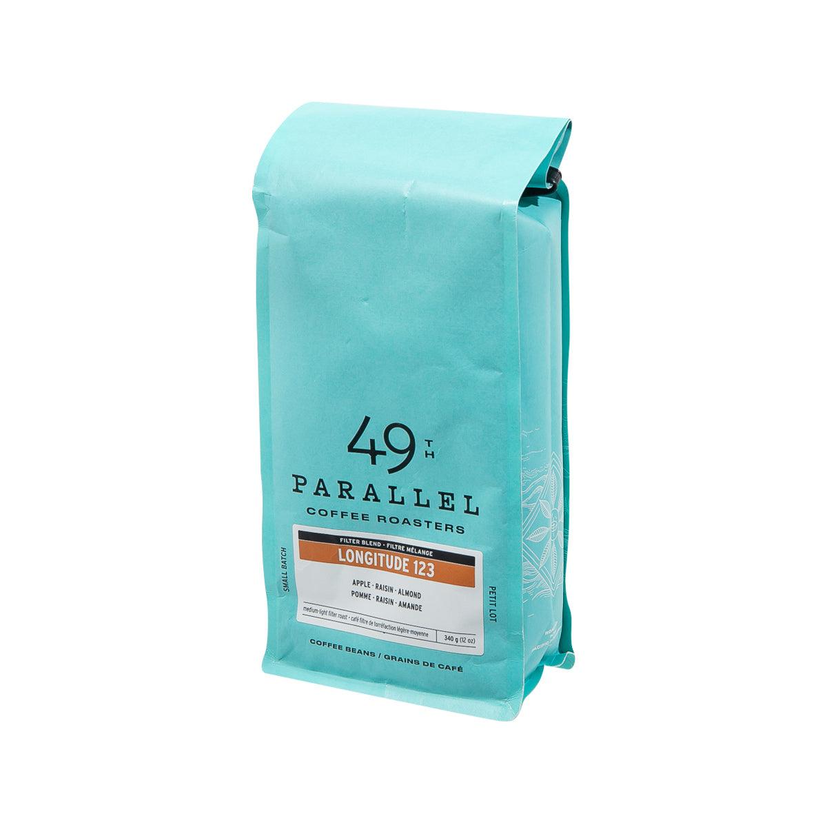 Medium-light roast coffee bean pouch, teal bag with side view and Longitude 123 tag