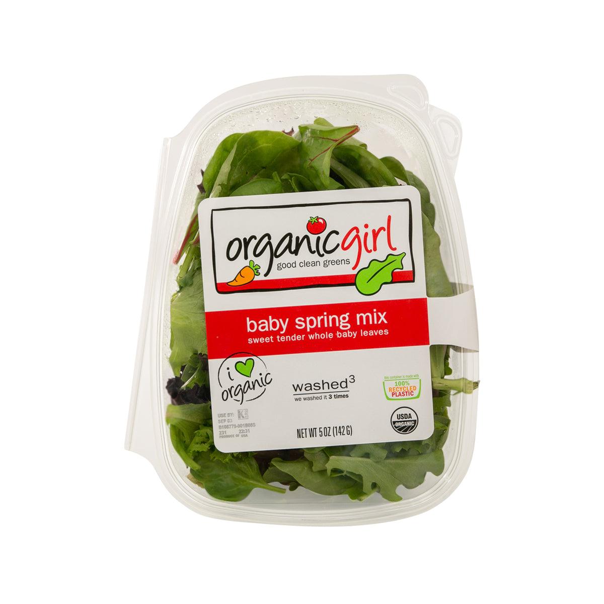 Packaged organic baby spring mix salad in clear plastic clamshell container