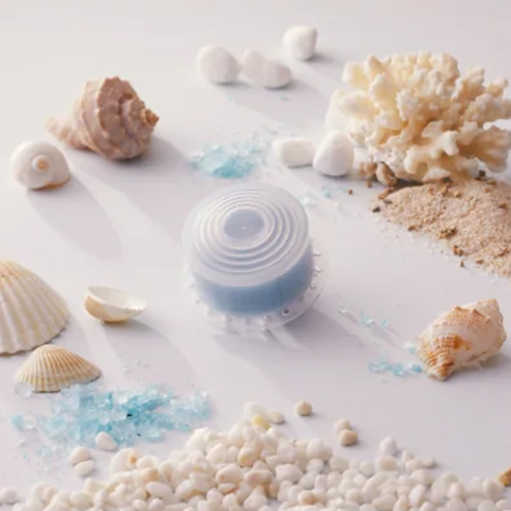 Translucent shower filter cartridge with blue media, shells and white beads
