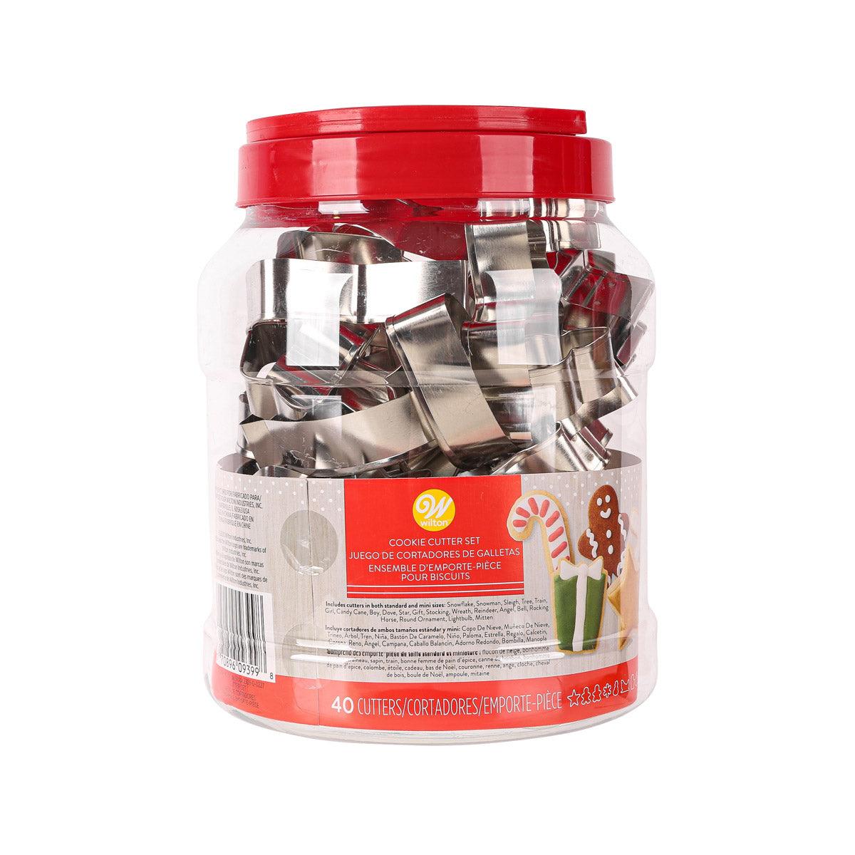 Clear jar with red lid holding 40-piece set of metal Christmas cookie cutters