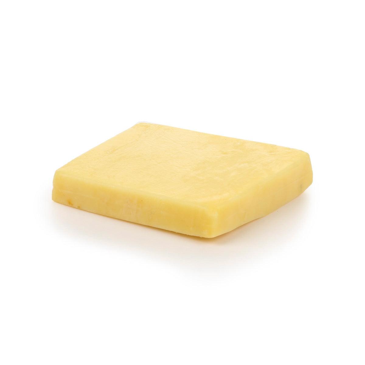 Cheddar cheese wedge, pale yellow rectangular block