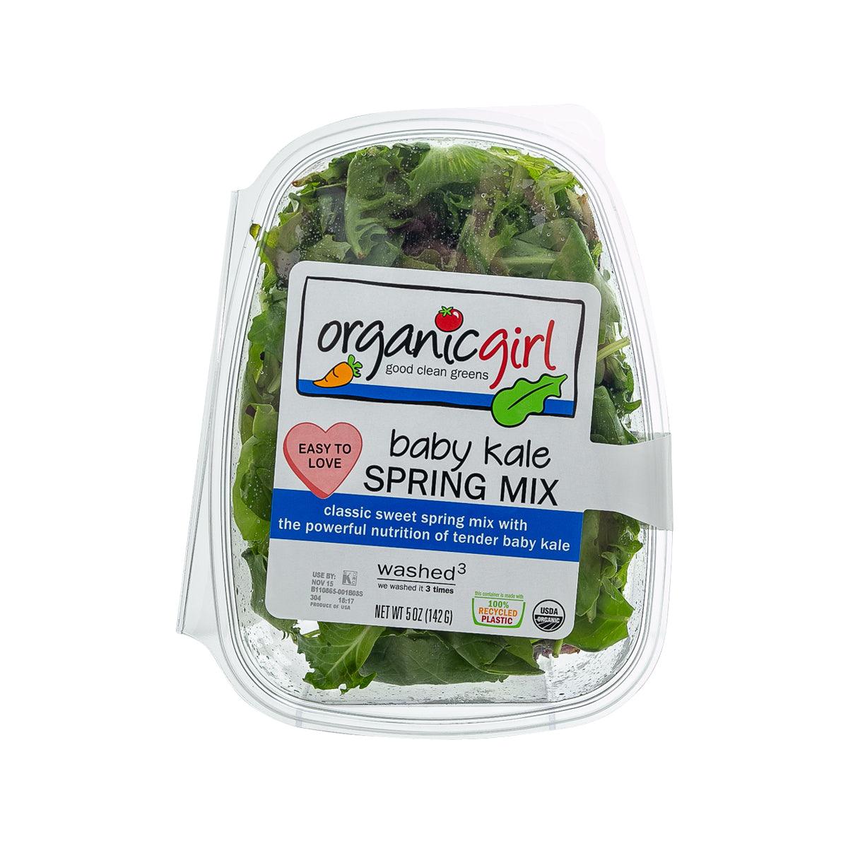 Organic baby kale spring mix salad in clear plastic container, green leaves
