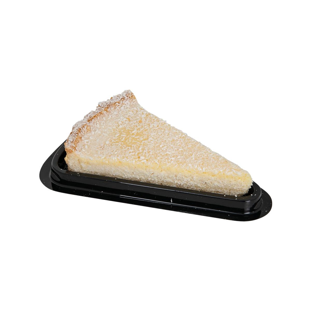 Coconut tart slice on black plastic tray, golden crumb and flaky crust