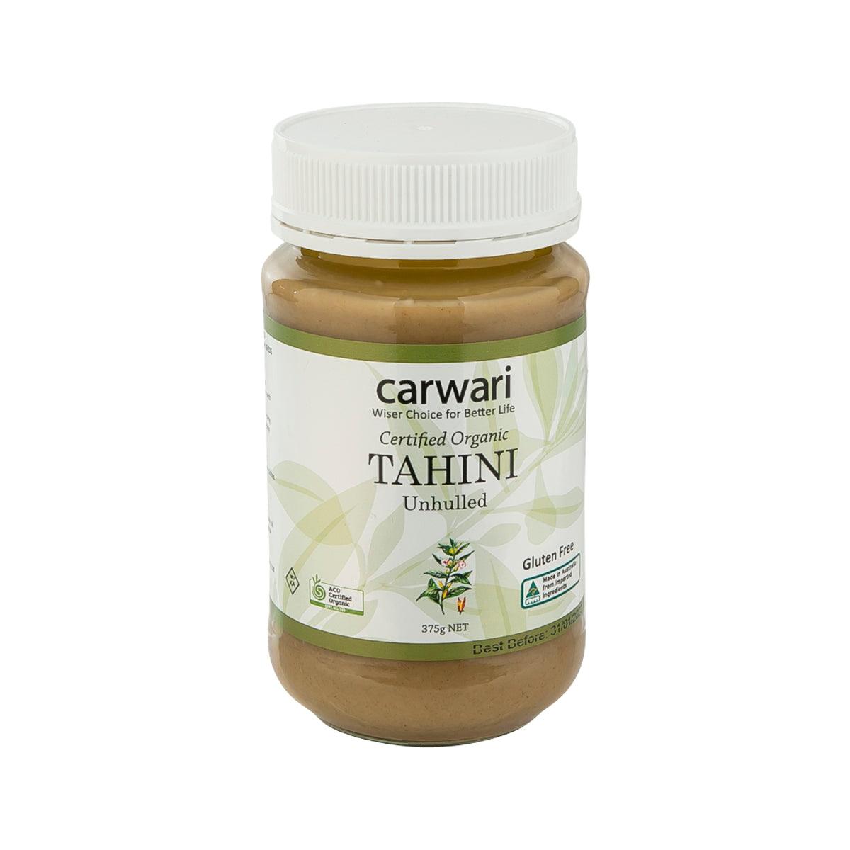 Organic unhulled tahini jar with white ribbed lid and brown paste