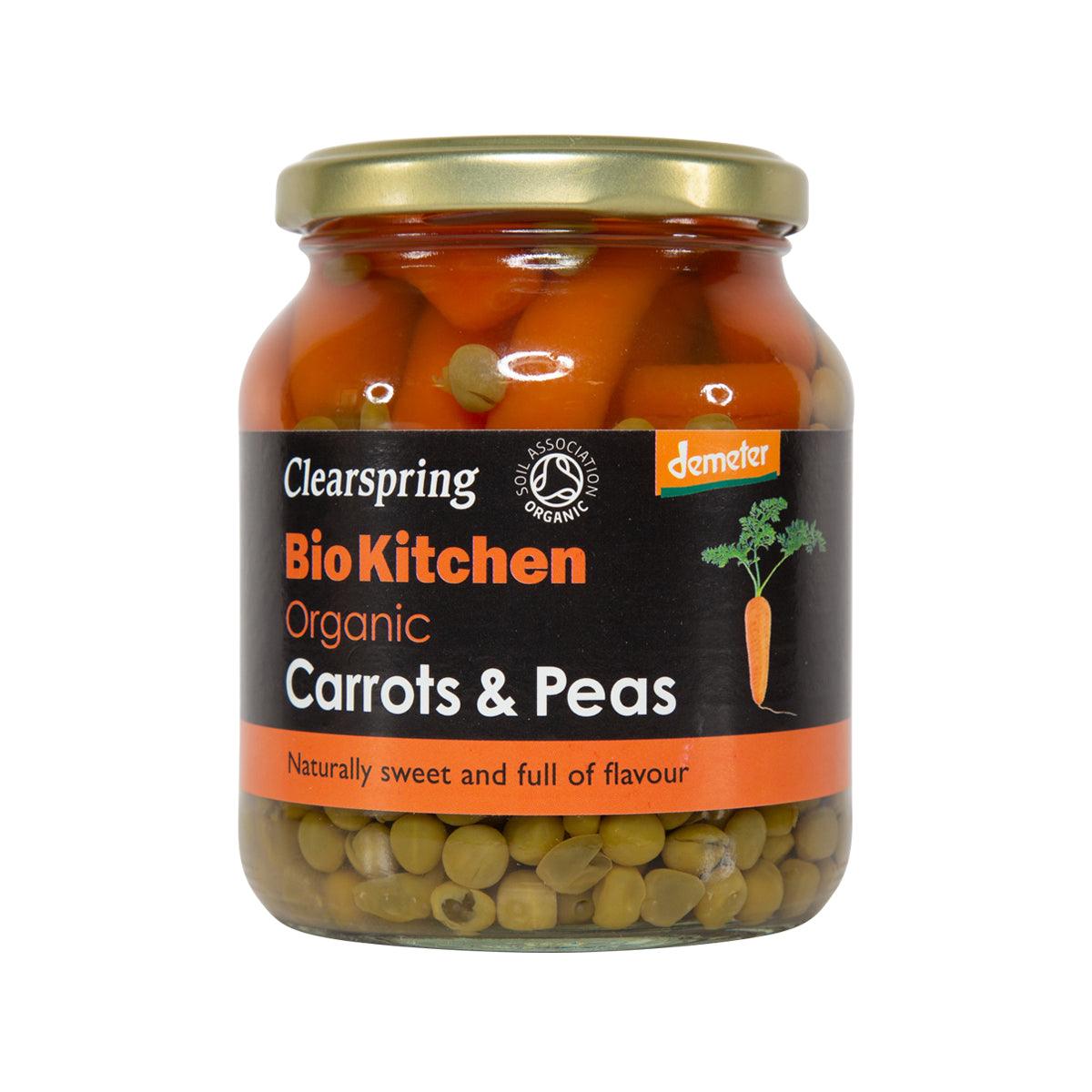 Organic carrots and peas in glass jar with lid, visible peas through front