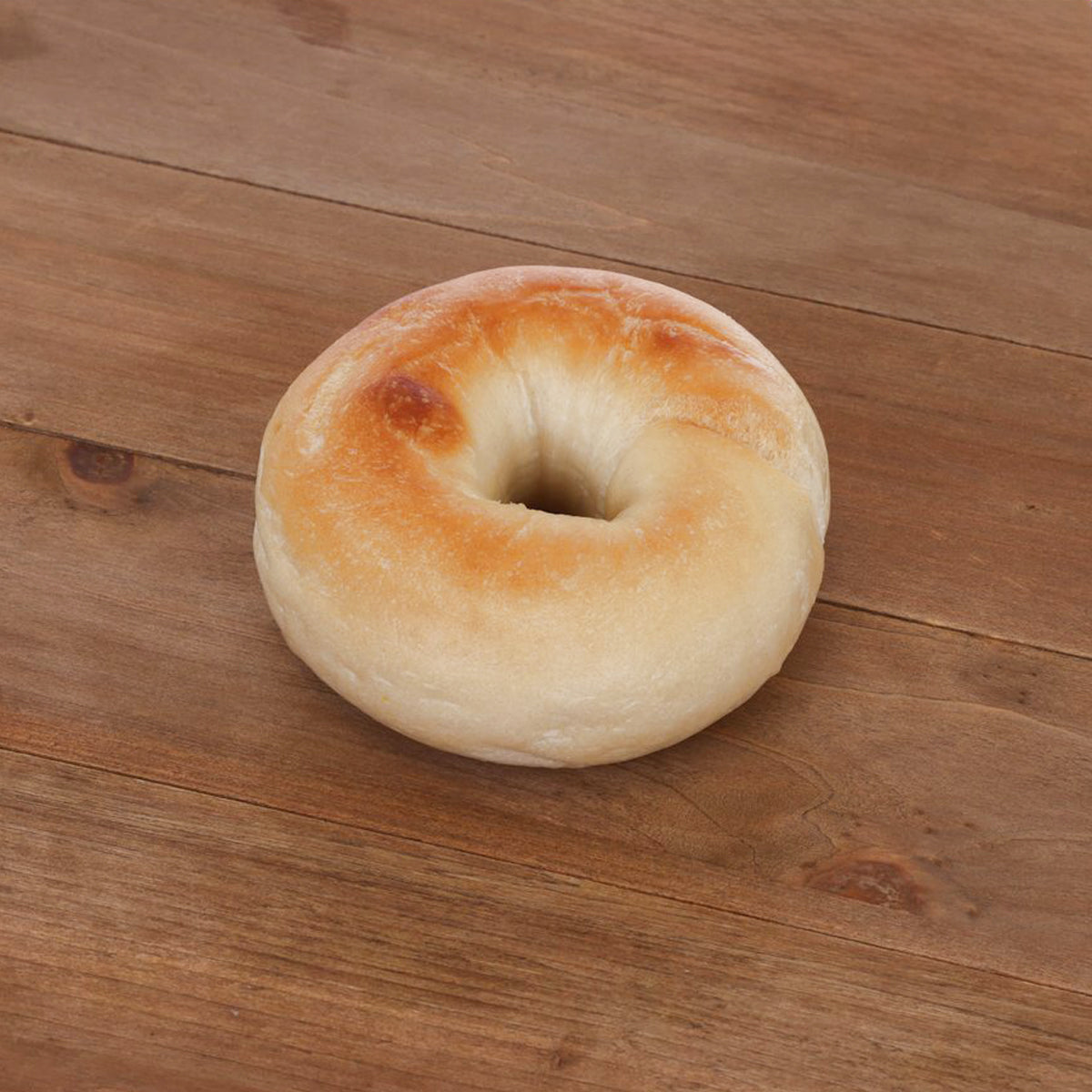 Plain bagel with golden-brown crust and pale, soft inside