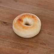 Plain bagel with golden-brown crust and pale, soft inside