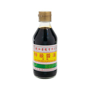 Premium soy sauce bottle with dark glass and gold cap, front label