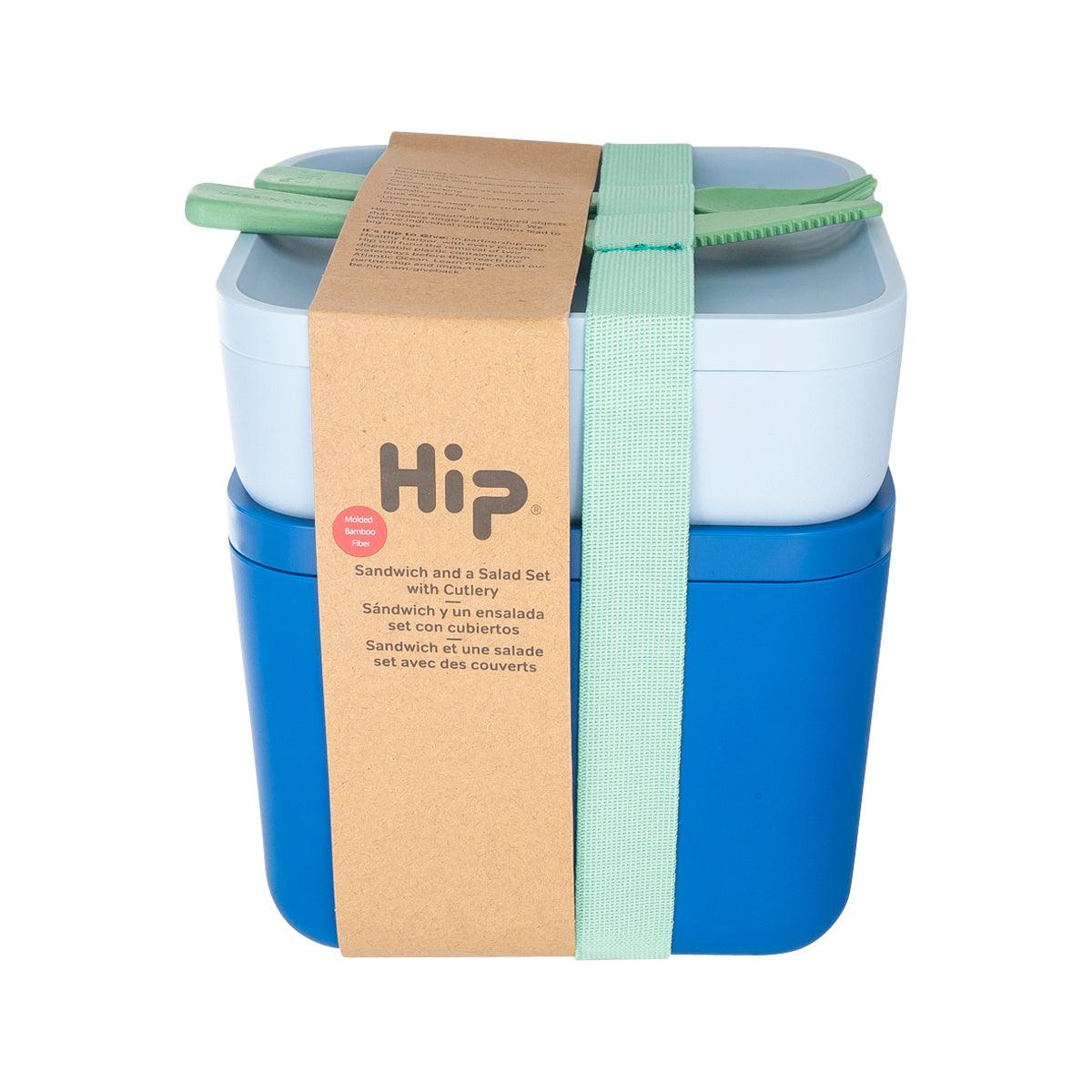 Two-tier lunch container with blue base, light top, green fork and knife, in wrap